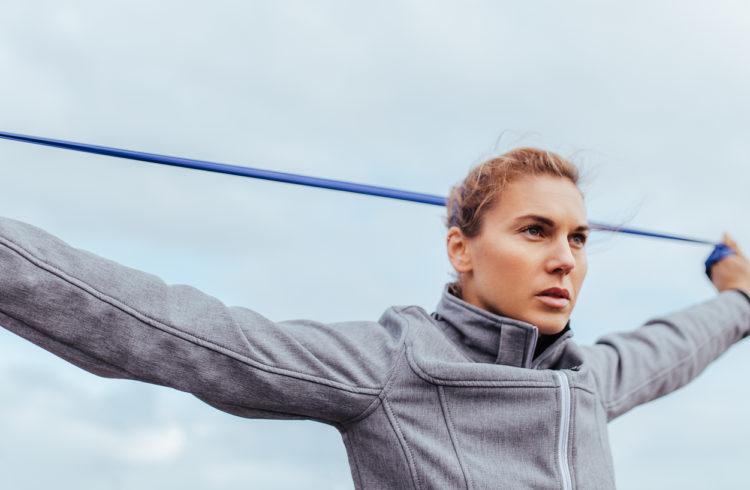 eos gym member looking focused while doing Resistance Band Training