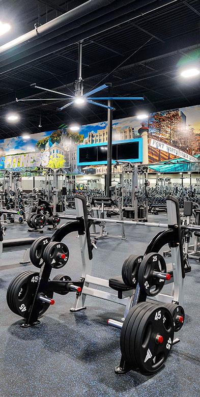 a wide shot of the interior of a large eos branded box gym