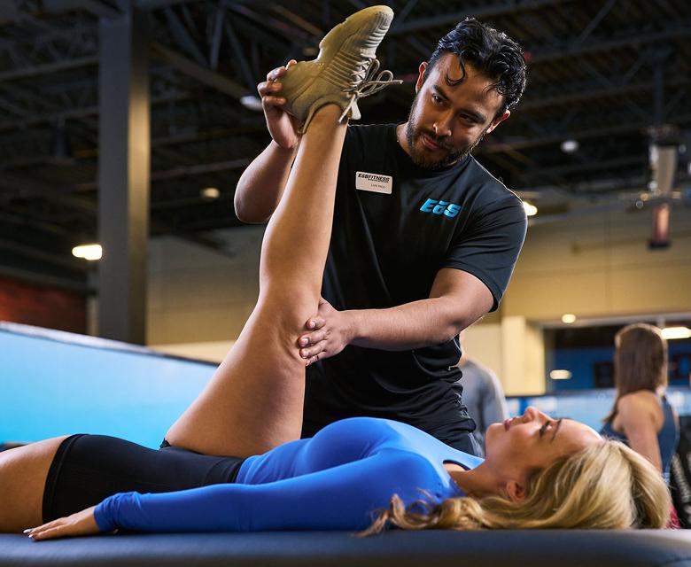 eos gym member getting their leg stretched out