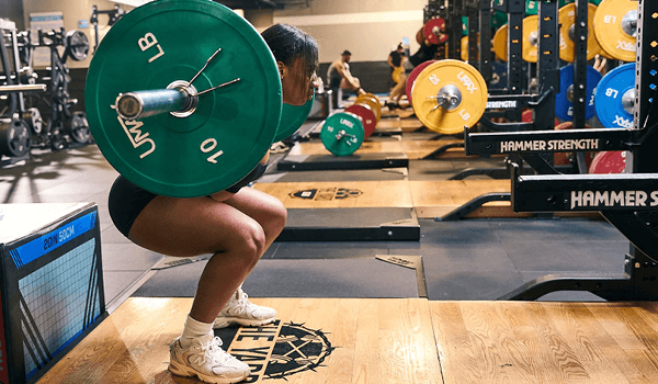 eos gym member doing squats
