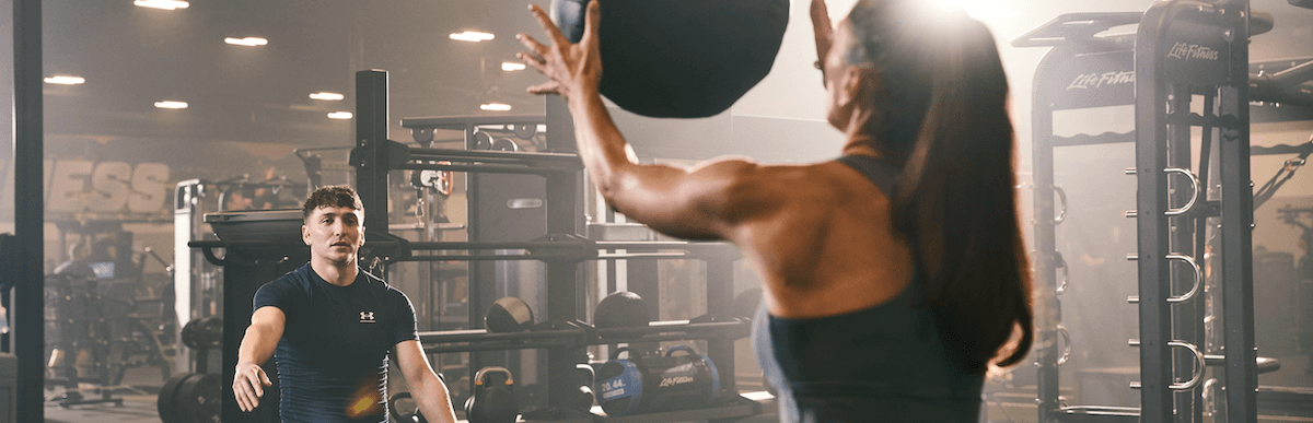 two eos gym members working out with one another