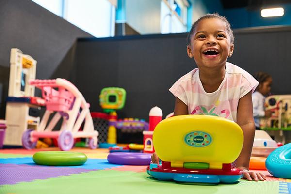 Child playing with toys in the EōS Kids’ Club daycare