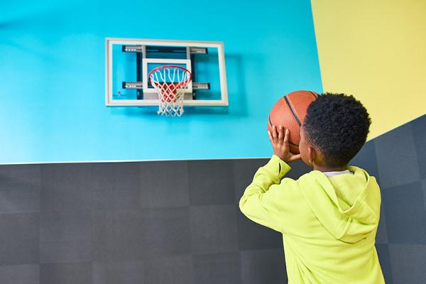 Kiddo at EōS Kids’ Club playing basketball