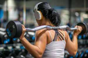 woman wearing headphones working out in gym